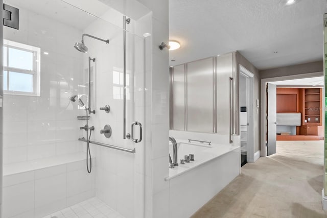 bathroom with separate shower and tub and a textured ceiling