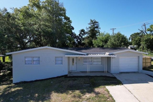 single story home featuring a front lawn and a garage