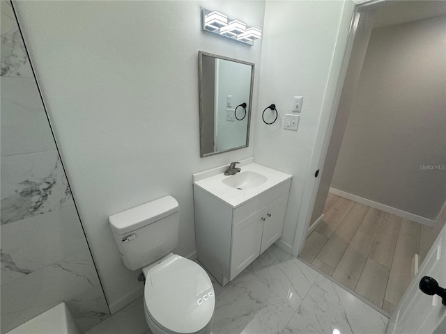 bathroom with toilet, vanity with extensive cabinet space, and tile flooring