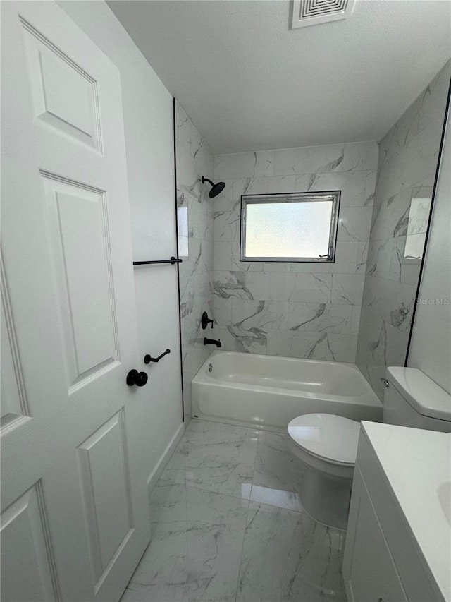 full bathroom with tiled shower / bath combo, vanity, toilet, and tile flooring