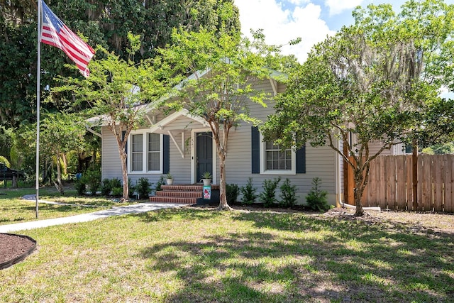 obstructed view of property featuring a front lawn