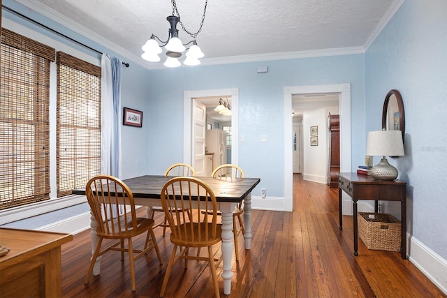 dining area featuring crown molding, plenty of natural light, and dark hardwood / wood-style floors