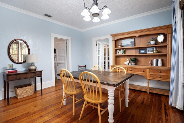 dining space with crown molding, dark hardwood / wood-style floors, and a textured ceiling