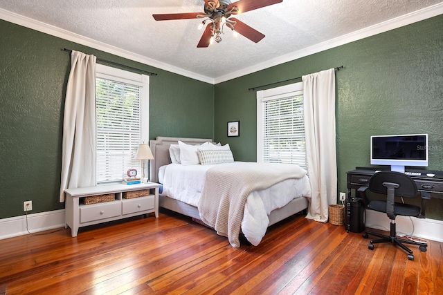 bedroom featuring hardwood / wood-style floors, ceiling fan, ornamental molding, and a textured ceiling