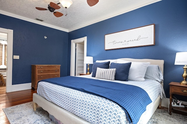 bedroom with a textured ceiling, ceiling fan, crown molding, and hardwood / wood-style flooring