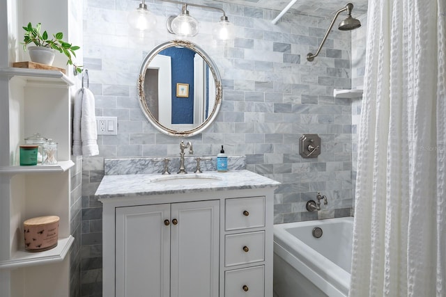 bathroom featuring vanity, shower / bath combo with shower curtain, and tile walls