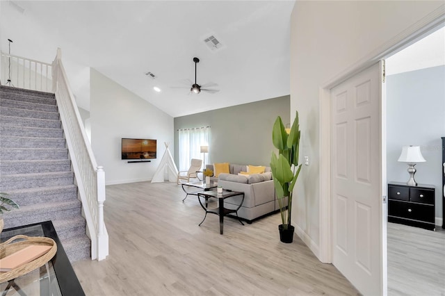 interior space featuring light wood-type flooring, vaulted ceiling, and ceiling fan