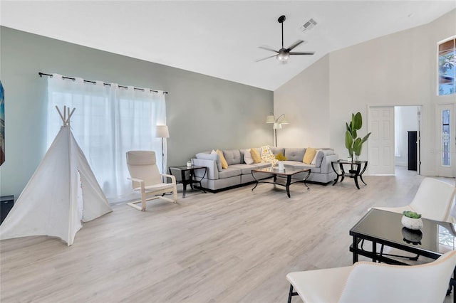 living room featuring ceiling fan, a healthy amount of sunlight, and light wood-type flooring