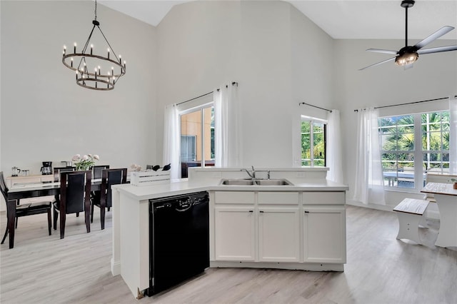 kitchen with light hardwood / wood-style flooring, dishwasher, hanging light fixtures, sink, and white cabinets