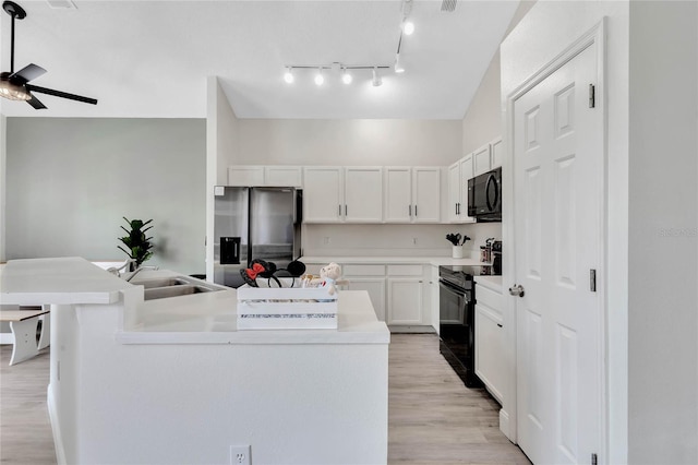 kitchen featuring light hardwood / wood-style floors, black appliances, white cabinets, sink, and ceiling fan