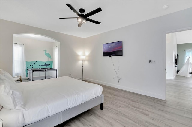 bedroom with ceiling fan and light hardwood / wood-style floors