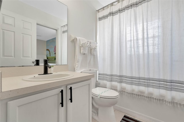 bathroom featuring vanity with extensive cabinet space and toilet