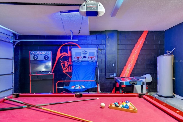 recreation room with a textured ceiling, pool table, and water heater