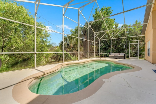 view of pool with a patio area and a lanai