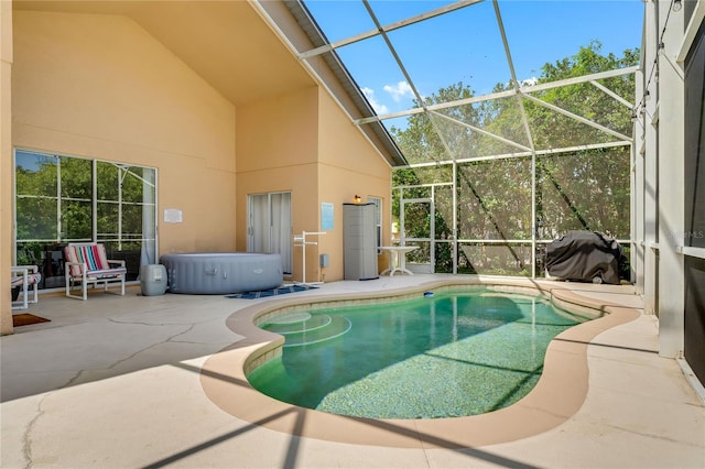 view of swimming pool with a lanai and a patio