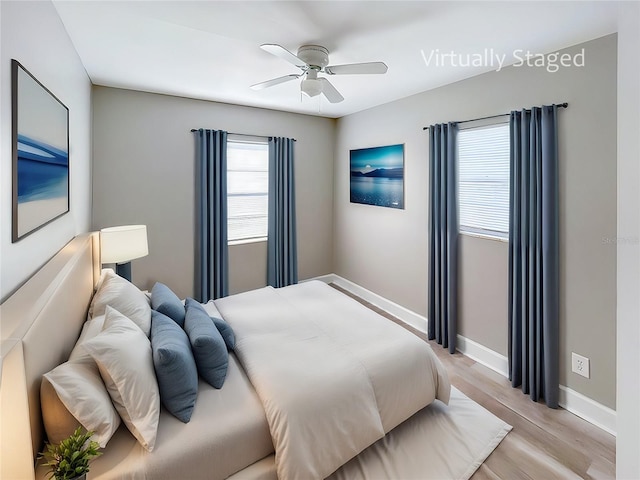 bedroom with light hardwood / wood-style floors and ceiling fan