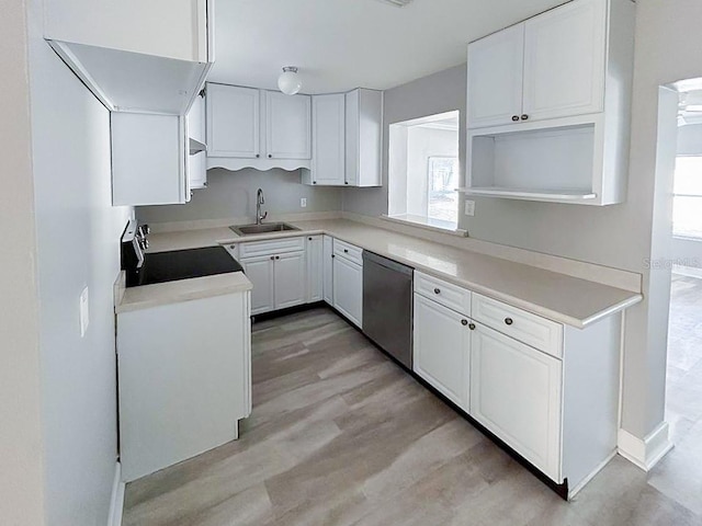 kitchen with light hardwood / wood-style floors, stove, white cabinetry, stainless steel dishwasher, and sink