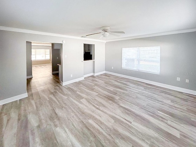 spare room featuring ceiling fan, ornamental molding, and wood-type flooring