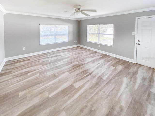 spare room with ceiling fan, ornamental molding, and light hardwood / wood-style floors