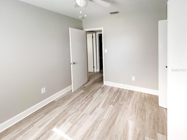 empty room with ceiling fan and light wood-type flooring