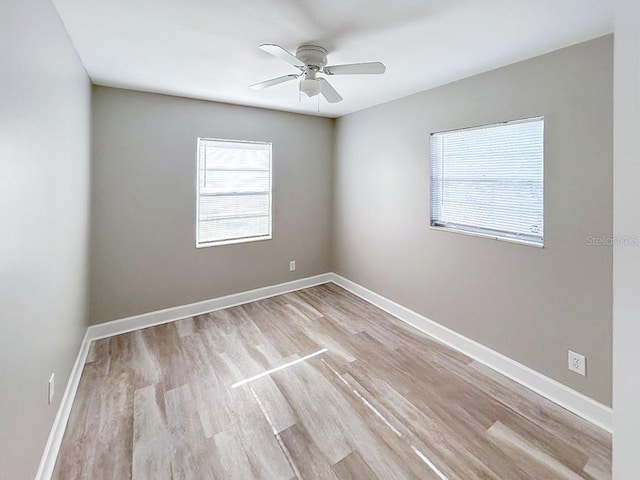 empty room with light wood-type flooring and ceiling fan