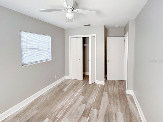 unfurnished bedroom with a closet, ceiling fan, and light wood-type flooring