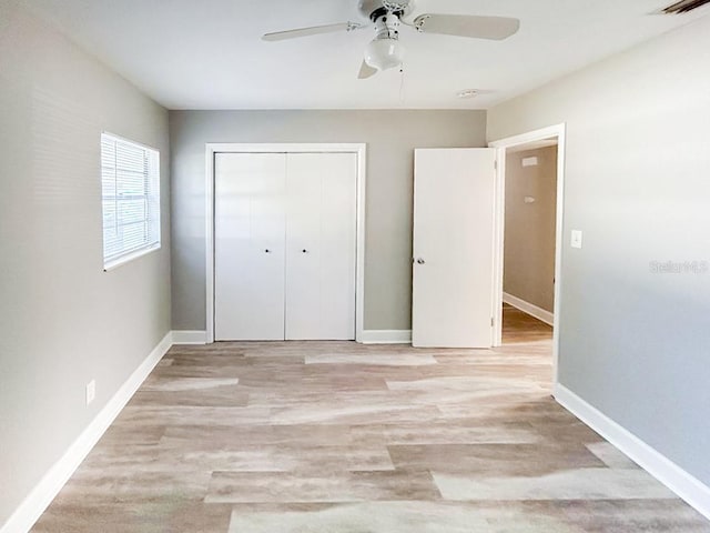 unfurnished bedroom with a closet, ceiling fan, and light hardwood / wood-style flooring