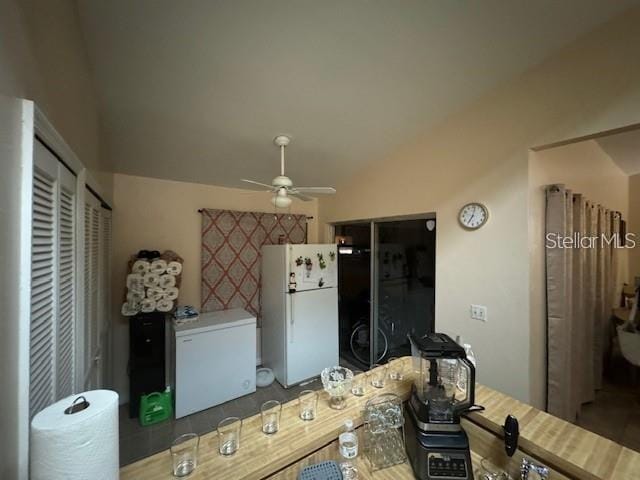 interior space featuring white refrigerator, ceiling fan, and fridge