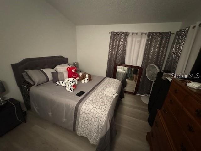 bedroom with wood-type flooring