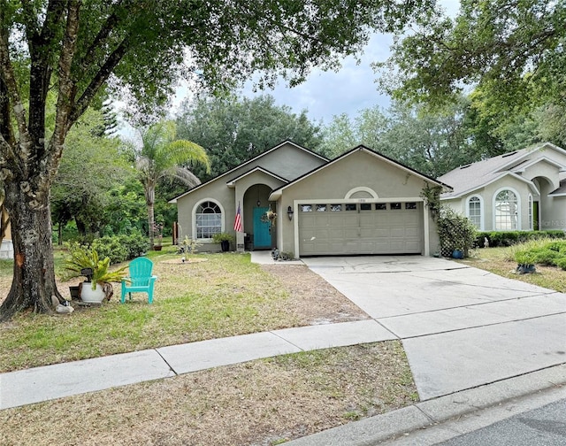 ranch-style home featuring a garage and a front yard