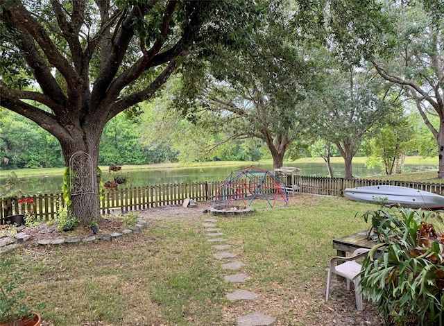 view of yard featuring a playground and a water view