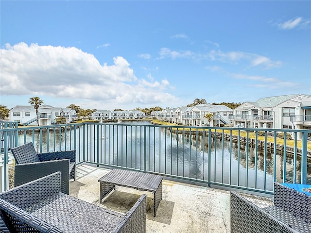 balcony with outdoor lounge area and a water view