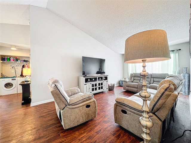 living room with hardwood / wood-style floors, lofted ceiling, a textured ceiling, and washer and clothes dryer