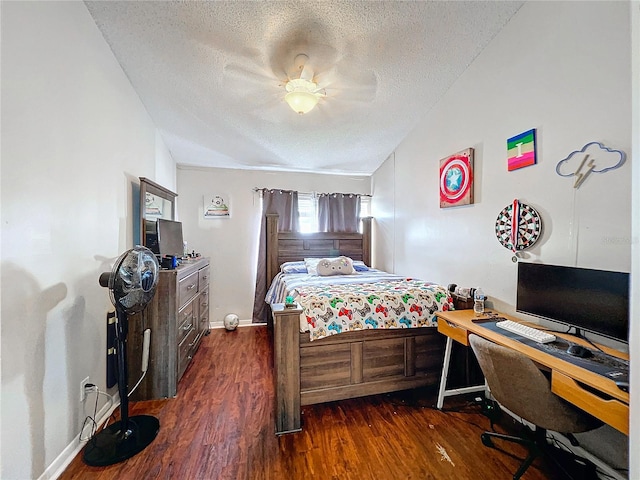 bedroom featuring ceiling fan, dark wood-type flooring, and a textured ceiling