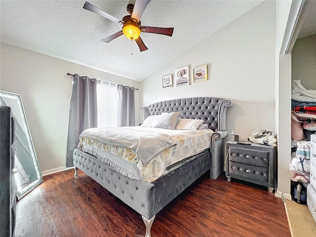 bedroom featuring wood-type flooring, ceiling fan, lofted ceiling, and a textured ceiling