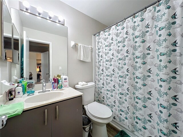 bathroom featuring hardwood / wood-style flooring, vanity, and toilet