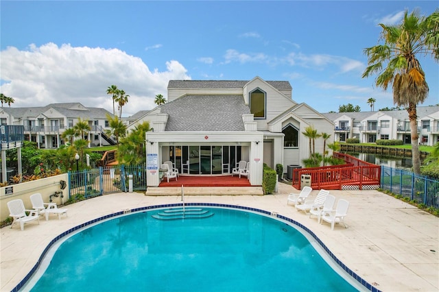 view of swimming pool featuring central air condition unit and a patio