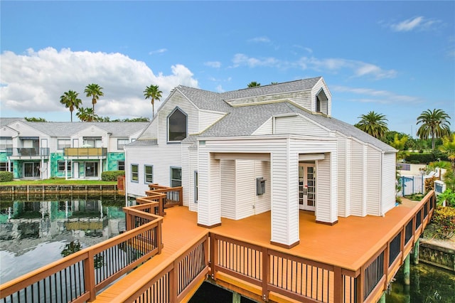 rear view of house featuring a wooden deck and a balcony