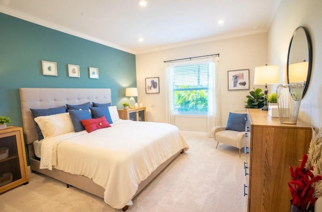 bedroom with ornamental molding and light colored carpet