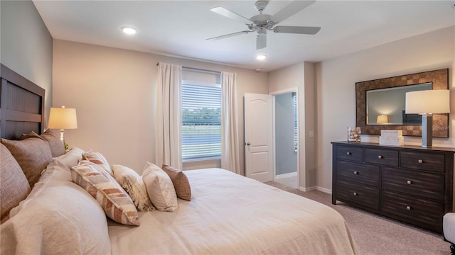 bedroom with ceiling fan and light colored carpet