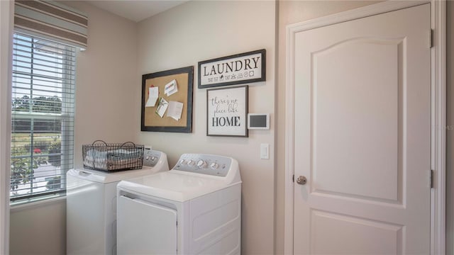 clothes washing area with separate washer and dryer