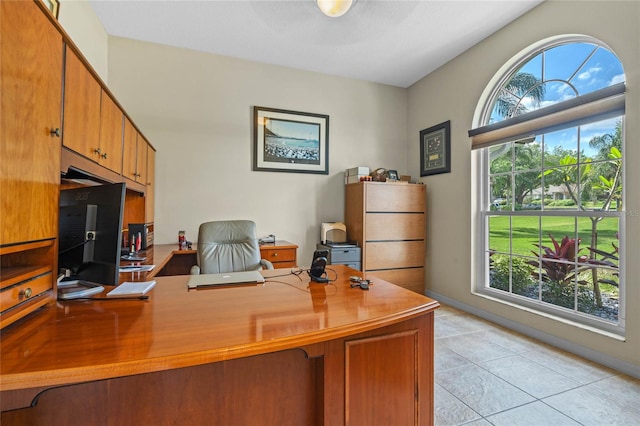 office space with a healthy amount of sunlight and light tile flooring