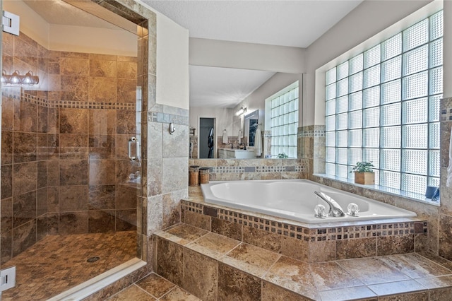 bathroom with tile flooring and separate shower and tub