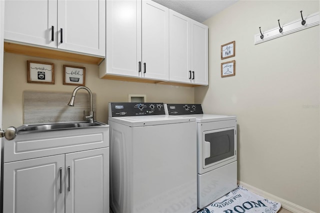 laundry area with cabinets, sink, and independent washer and dryer