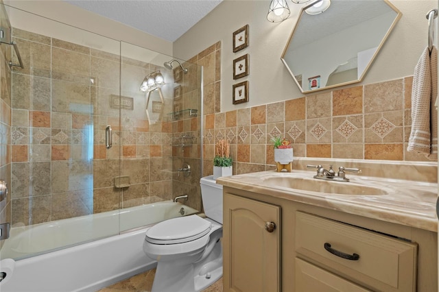 full bathroom featuring backsplash, enclosed tub / shower combo, oversized vanity, toilet, and a textured ceiling