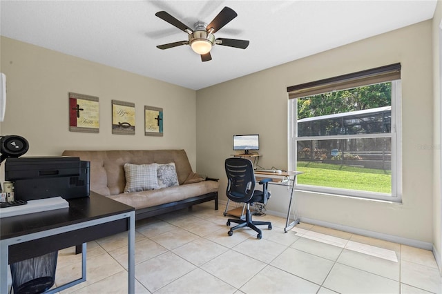 home office with plenty of natural light, ceiling fan, and light tile floors