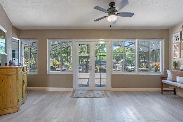 doorway to outside featuring a textured ceiling, ceiling fan, and light hardwood / wood-style floors