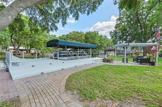 view of property's community with a dock and a lawn