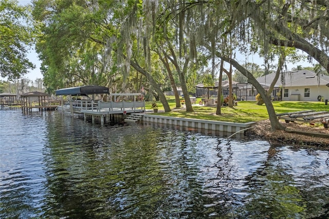 dock area featuring a water view and a yard