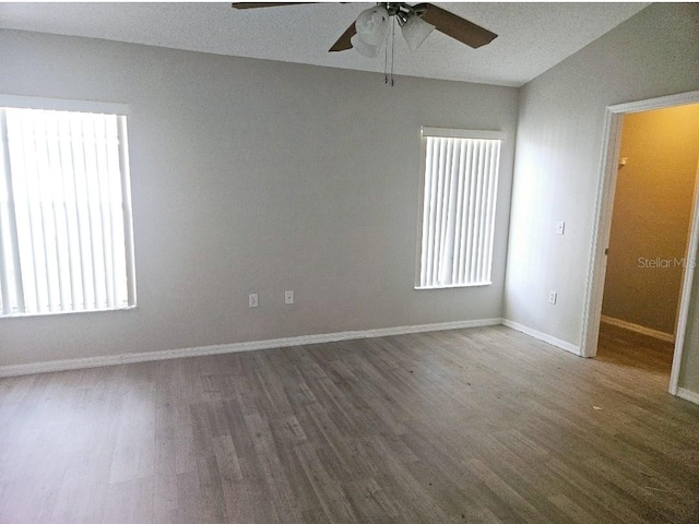 unfurnished room featuring dark hardwood / wood-style flooring and ceiling fan